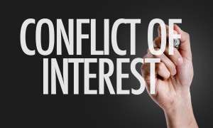 Hand writing the text: Conflict of Interest